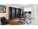 Office with large window and hardwood floors, accentuated by built-in shelving at 19113 W 60Th Ln, Golden, CO 80403