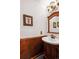 Cozy powder room featuring wood accents, framed art and classic fixtures at 19113 W 60Th Ln, Golden, CO 80403