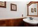 Traditional powder room with wainscoting, and a decorative mirror at 19113 W 60Th Ln, Golden, CO 80403