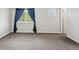 Bright bedroom with blue curtains and neutral carpet at 17391 E Weaver Ave, Aurora, CO 80016