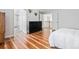 Bedroom showcasing hardwood floors, neutral walls, and staircase with railing at 17391 E Weaver Ave, Aurora, CO 80016