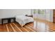 Bright bedroom featuring hardwood floors, large windows, and ample natural light at 17391 E Weaver Ave, Aurora, CO 80016