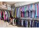 Walk-in closet providing plenty of storage space with racks of hanging clothes at 17391 E Weaver Ave, Aurora, CO 80016