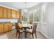Dining area features a round wood table and a lot of natural light from the surrounding windows at 17391 E Weaver Ave, Aurora, CO 80016