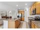 Kitchen with stainless appliances, granite countertops, island, and easy access to the living room at 17391 E Weaver Ave, Aurora, CO 80016