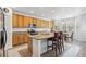 Eat-in kitchen featuring stainless steel appliances, tile floors, and a kitchen island at 17391 E Weaver Ave, Aurora, CO 80016