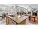 Kitchen with island, stainless appliances, view of the living room fireplace, and an eat-in area at 17391 E Weaver Ave, Aurora, CO 80016