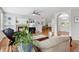 Bright living room features a cozy fireplace, hardwood floors, and archways to other rooms at 17391 E Weaver Ave, Aurora, CO 80016