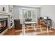 Bright living room with fireplace, hardwood floors and a bay window offering natural light at 17391 E Weaver Ave, Aurora, CO 80016