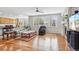 Open-concept living room with fireplace, ceiling fan, and hardwood floors at 17391 E Weaver Ave, Aurora, CO 80016