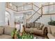 Open-concept living room features hardwood floors, a staircase, and cozy seating at 17391 E Weaver Ave, Aurora, CO 80016
