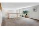 Open loft area with plush carpeting, natural light, and decorative wood banister at 17391 E Weaver Ave, Aurora, CO 80016