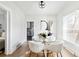 Bright dining area features modern decor and a glass top table at 4134 Bryant St, Denver, CO 80211