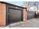 Two-car garage showcasing brick facade and modern doors at 4134 Bryant St, Denver, CO 80211