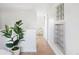 Inviting hallway featuring light hardwood floors, white walls, and modern decor at 4134 Bryant St, Denver, CO 80211