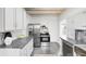 This spacious kitchen features stainless steel appliances, white cabinetry, and a tiled floor at 4134 Bryant St, Denver, CO 80211