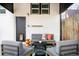 Inviting covered patio featuring stylish outdoor seating and a patterned rug at 4134 Bryant St, Denver, CO 80211