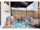 Inviting covered patio featuring stylish outdoor seating, a patterned rug, and a privacy fence at 4134 Bryant St, Denver, CO 80211