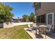 Fenced backyard featuring a patio set on a concrete pad, grass and an enclosed shed at 750 S Dearborn Ct, Aurora, CO 80012