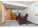 Finished basement featuring neutral carpeting, built-in storage, and an office area at 750 S Dearborn Ct, Aurora, CO 80012