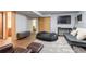 Finished basement with modern vinyl flooring, seating, and a large screen television at 750 S Dearborn Ct, Aurora, CO 80012