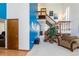 Open concept living area features a two-story staircase, decoratively painted walls and an abundance of natural light at 750 S Dearborn Ct, Aurora, CO 80012