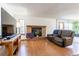 Cozy living room features a brick fireplace, wood flooring, and comfortable seating at 750 S Dearborn Ct, Aurora, CO 80012