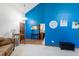 Vibrant living room showcases an accent wall, wood floors, stylish console table and comfortable couch at 750 S Dearborn Ct, Aurora, CO 80012