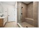 Spa-like bathroom featuring a tiled shower with a glass door, modern fixtures and a bench at 1601 Park Ave # 506, Denver, CO 80218