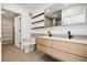 Modern bathroom with double vanity, sleek fixtures, and open shelving for storage at 1601 Park Ave # 506, Denver, CO 80218