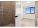 Modern bathroom featuring a glass-enclosed shower and bright lighting near the bedroom at 1601 Park Ave # 506, Denver, CO 80218