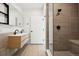 Sleek bathroom featuring double sinks, a modern vanity, and a luxurious glass-enclosed shower at 1601 Park Ave # 506, Denver, CO 80218