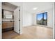 Bright bedroom with a bathroom and a large window, offering views of nature and abundant natural light at 1601 Park Ave # 506, Denver, CO 80218