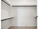 Bright walk-in closet with white walls, shelving and rod, and light wood floors at 1601 Park Ave # 506, Denver, CO 80218