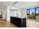 Bright modern kitchen with a black island and faucet, and a sliding door to the adjacent bedroom at 1601 Park Ave # 506, Denver, CO 80218