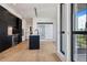 Modern kitchen with dark cabinetry, a kitchen island with a sink, and stainless steel appliances at 1601 Park Ave # 506, Denver, CO 80218