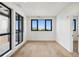Bright open room with wood floors, large windows, and sliding door, letting in natural light and beautiful views at 1601 Park Ave # 506, Denver, CO 80218
