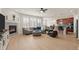 Bright, open living room featuring a fireplace, modern ceiling fan and large windows at 2414 Leafdale Cir, Castle Rock, CO 80109