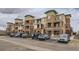 A multi-story condo building with balconies and parking in front showcases a modern architectural design at 4100 Albion St # 303, Denver, CO 80216