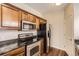 Well-equipped kitchen with stainless steel appliances, granite countertops, and wooden cabinetry for easy cooking at 4100 Albion St # 303, Denver, CO 80216