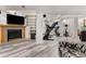 Spacious basement featuring a stone fireplace, shelving, and an exercise area at 2292 Brantner Pl, Brighton, CO 80601