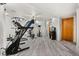 Basement area showcasing gym equipment and neutral paint, and wood-look floors at 2292 Brantner Pl, Brighton, CO 80601