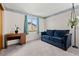 Cozy bedroom with a blue sofa and a desk by the window at 2292 Brantner Pl, Brighton, CO 80601