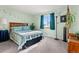 Charming bedroom with colorful wall decals, a bed with a patterned quilt, and natural light at 2292 Brantner Pl, Brighton, CO 80601