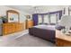 Spacious primary bedroom with neutral walls, ceiling fan, windows and carpeted floor at 2292 Brantner Pl, Brighton, CO 80601