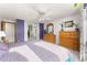 Large bedroom with ensuite bathroom featuring neutral walls, ceiling fan, windows and carpeted floor at 2292 Brantner Pl, Brighton, CO 80601