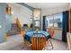Charming dining area with wooden table and chairs beneath a stylish chandelier at 2292 Brantner Pl, Brighton, CO 80601