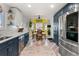Open kitchen flowing into dining area, showcasing cabinetry, stainless appliances, and modern design at 2292 Brantner Pl, Brighton, CO 80601