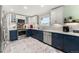 Bright kitchen features modern two-tone cabinets, stainless steel appliances, and stylish countertops at 2292 Brantner Pl, Brighton, CO 80601