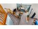 Bright living room with a couch, coffee table and staircase with wooden railings at 2292 Brantner Pl, Brighton, CO 80601